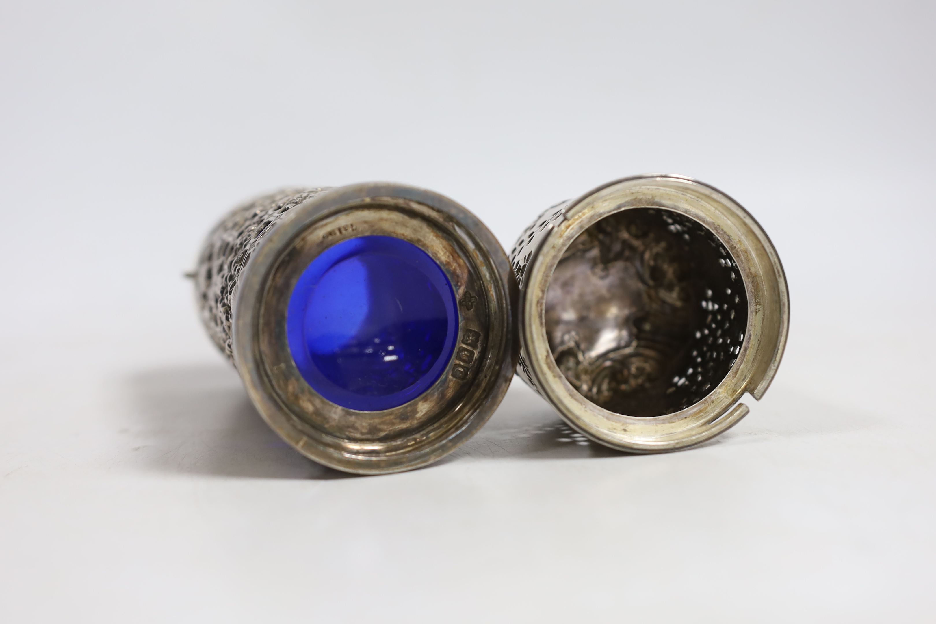 A late Victorian pierced silver lighthouse sugar caster, Horace Woodward & Co Ltd, London, 1898, with blue glass liner, 15.7cm.